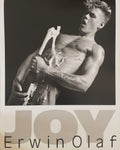 Erwin Olaf, Joy (Marc) (1985) poster: a black-and-white photograph of a bare-chested young man holding a bottle, with "JOY" and "Erwin Olaf" below.
