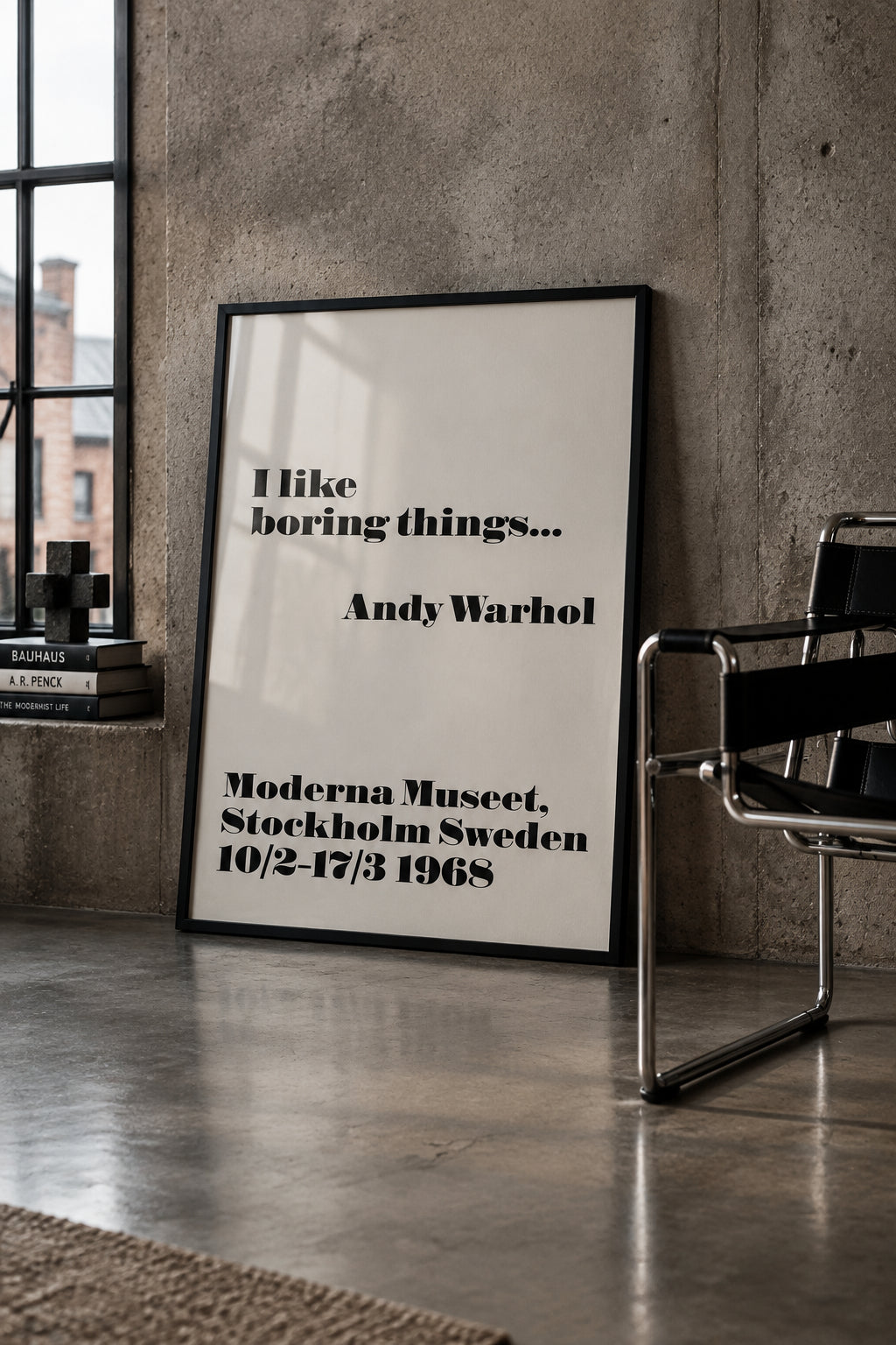 Andy Warhol, "I like boring things…", Moderna Museet 1968 poster, shown framed, leaning against a concrete wall beside a tubular steel chair.